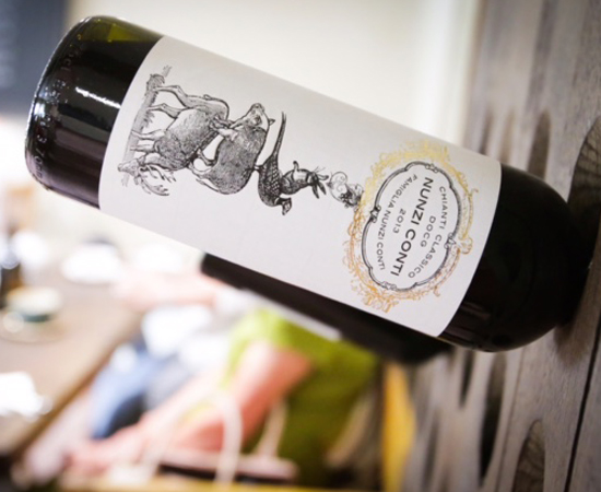 wine bottle held within a unique wooden rack 